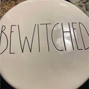 White Ceramic Rae Dunn cake stand with 'BEWITCHED' Text